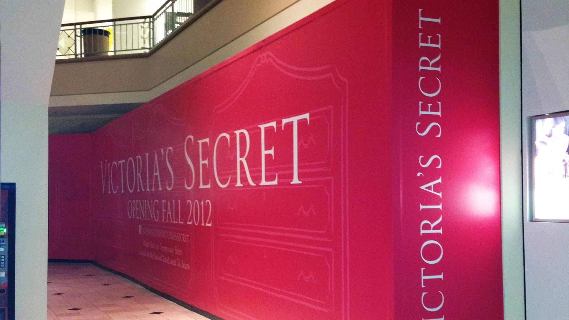 A red construction hoarding for a future Victoria's Secret store, marked 