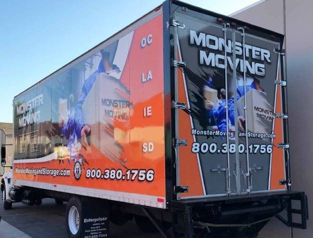 A Monster Moving delivery truck with orange and black branding, displaying the company name and phone number.