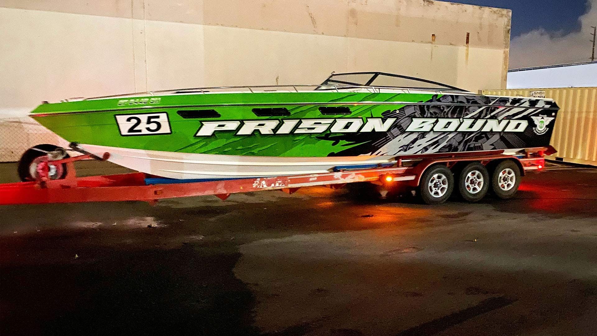 A green racing speedboat labeled 
