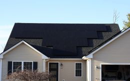 An aerial view of a house with solar panels on the roof