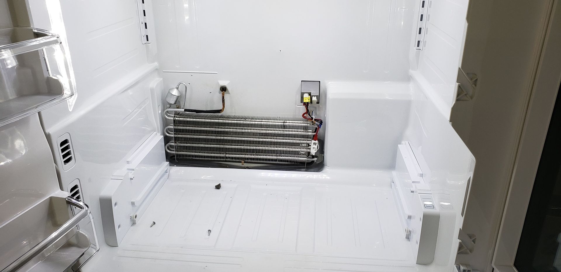 The inside of a refrigerator with the door open.