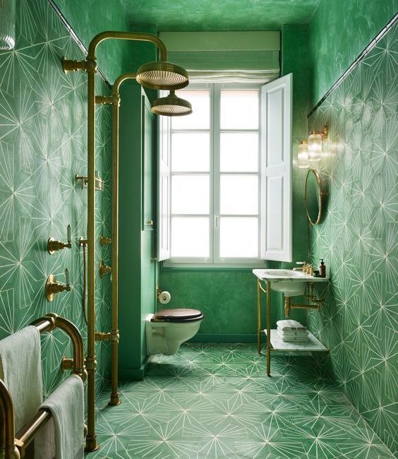 A geometric tiled bathroom in deep green