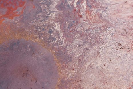 A close up of a purple and red marble texture.