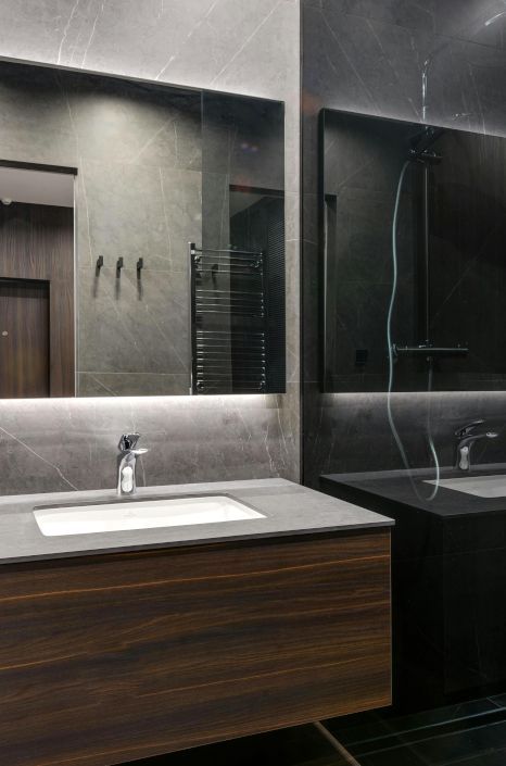 A bathroom with two sinks and a large mirror.