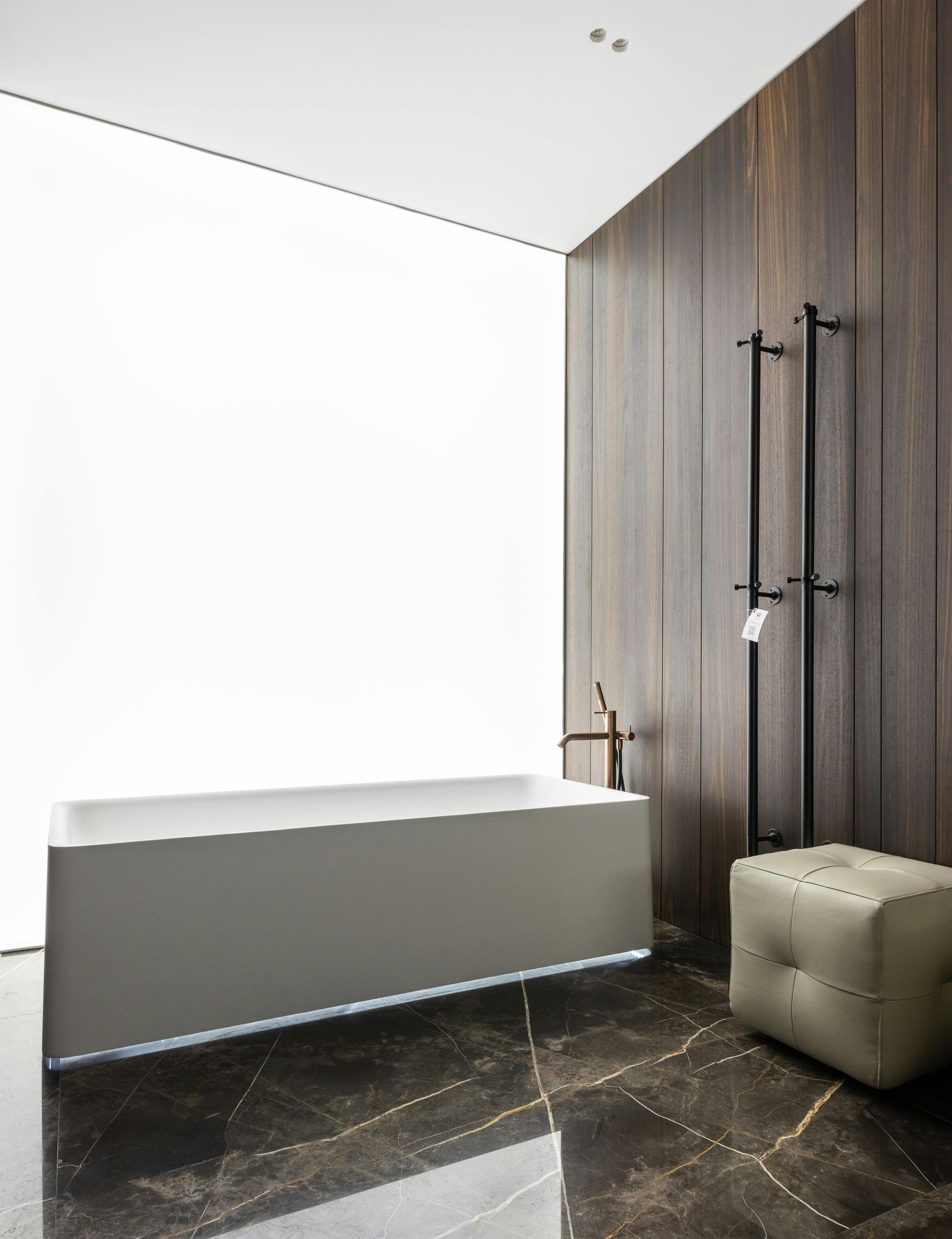 A modern, minimalist luxury bathroom with freestanding bathtub