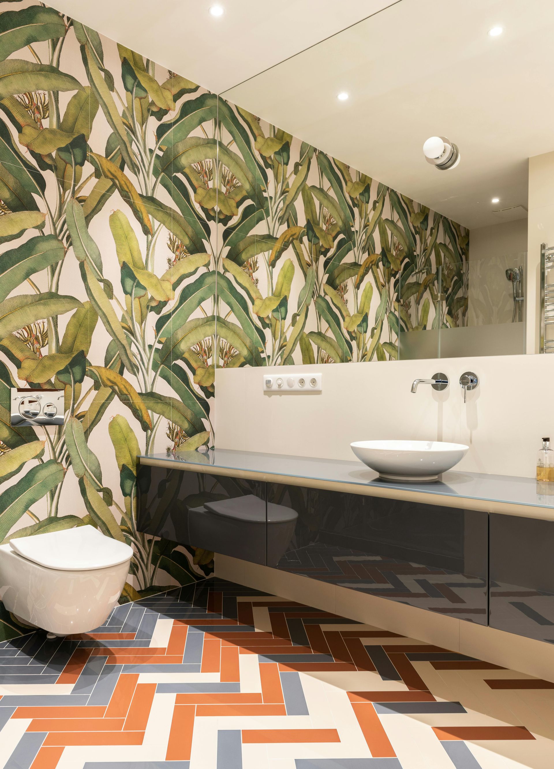 A bathroom with plant wallpaper