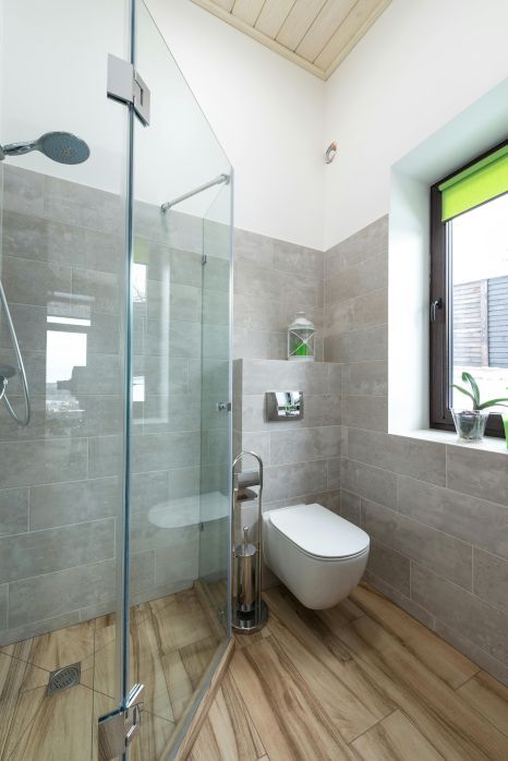 A bathroom with a walk in shower , toilet , and window in Stoke-on-Trent.