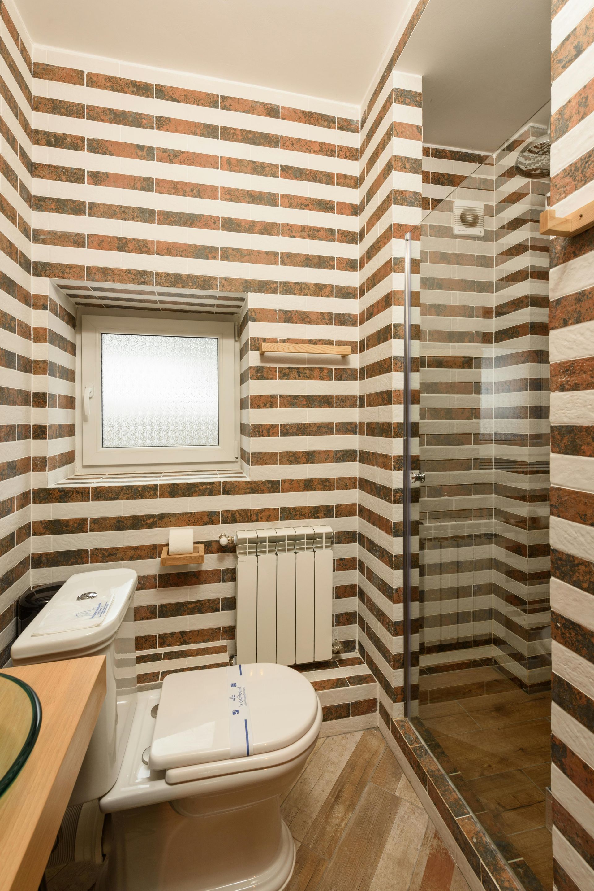 Earthy brown and cream tiled bathroom