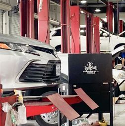 Lifted car on a ramp in a garage | Elite Auto Experts