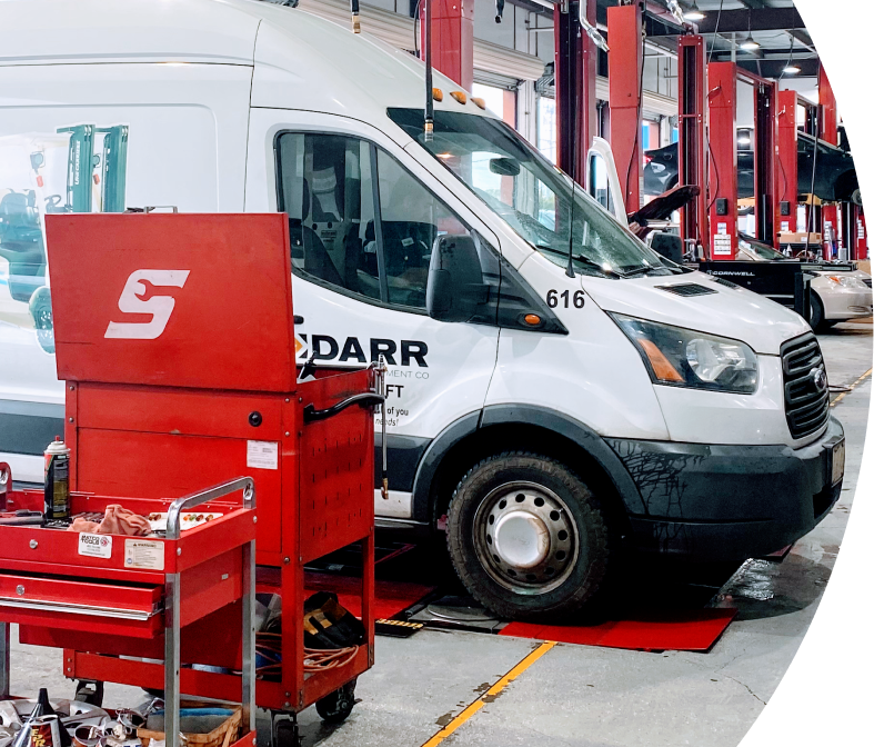 A white van is parked in a garage | | Elite Auto Experts