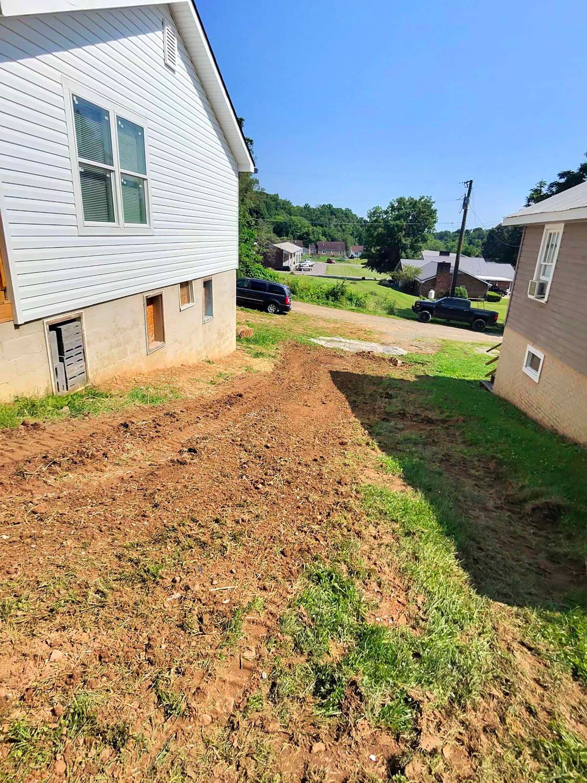 A house with a lot of dirt in front of it.