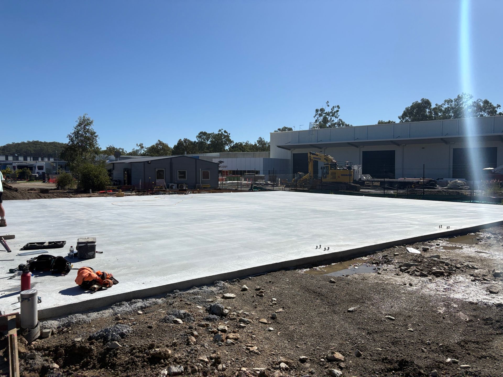A concrete floor is being built in front of a building.
