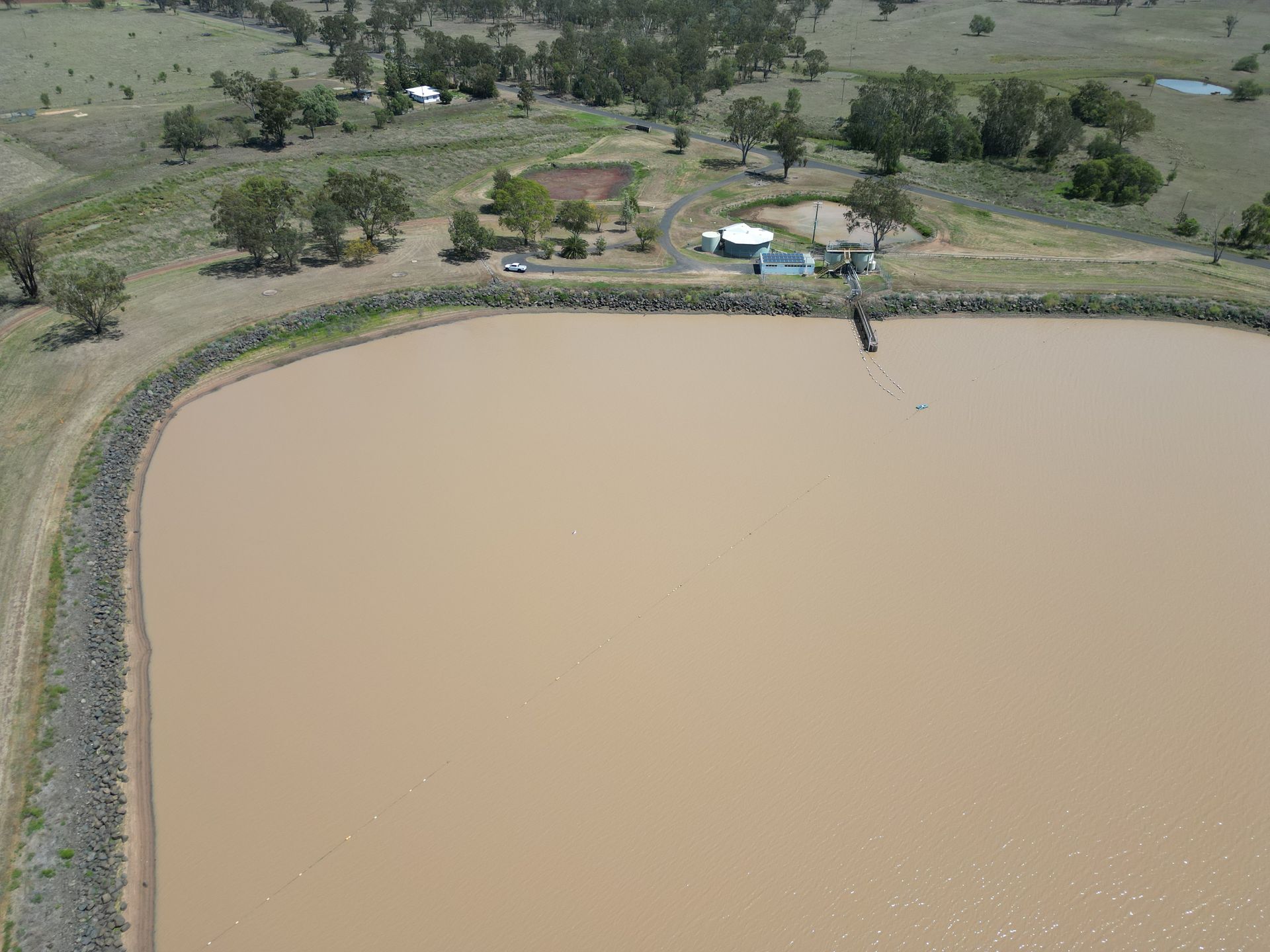 An aerial view of a large body of water surrounded by trees.
