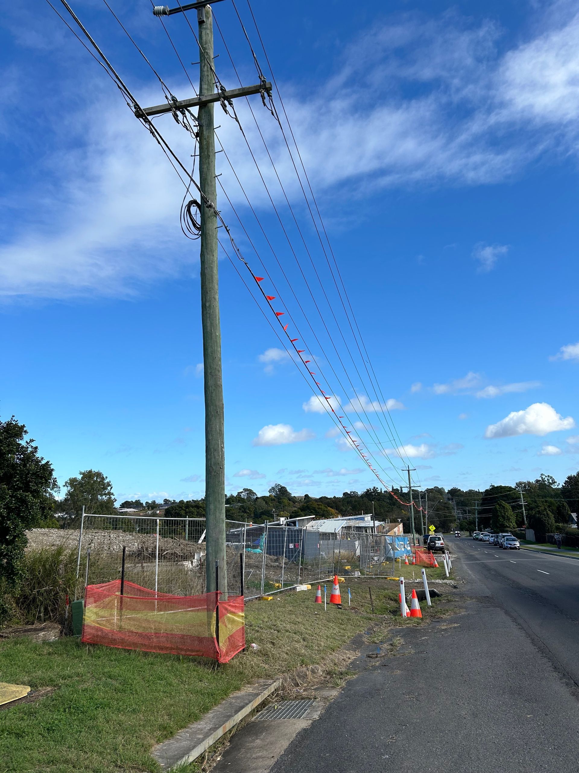 A telephone pole with a lot of wires hanging from it