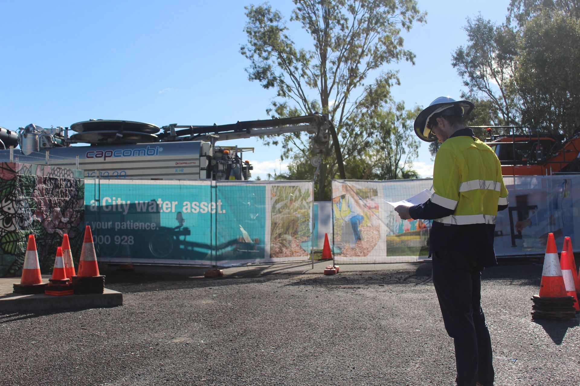 A man standing in front of a sign that says city water asset