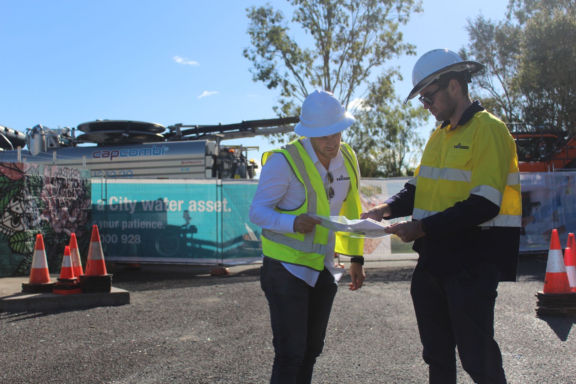 A man and a woman are standing next to each other on a road.