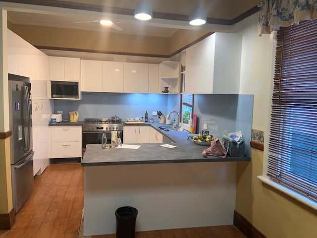 Kitchen With White Cabinets and Stainless Steel Appliances — Hancock Construction & Maintenance in Newcastle, NSW