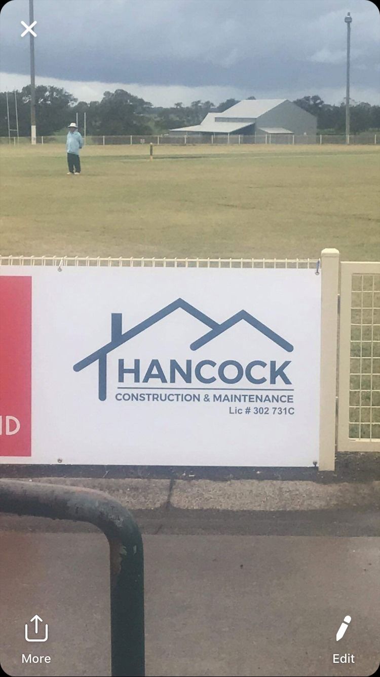 Sign That Says Hancock Construction is on a Fence — Hancock Construction & Maintenance in Newcastle, NSW