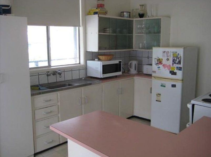 Kitchen With a White Refrigerator and a Pink Counter Top — Hancock Construction & Maintenance in Newcastle, NSW