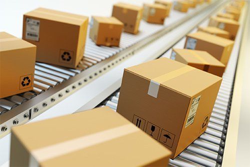 Cardboard Boxes In Conveyor Belt — Indianapolis, IN — Capitol City Container Corp