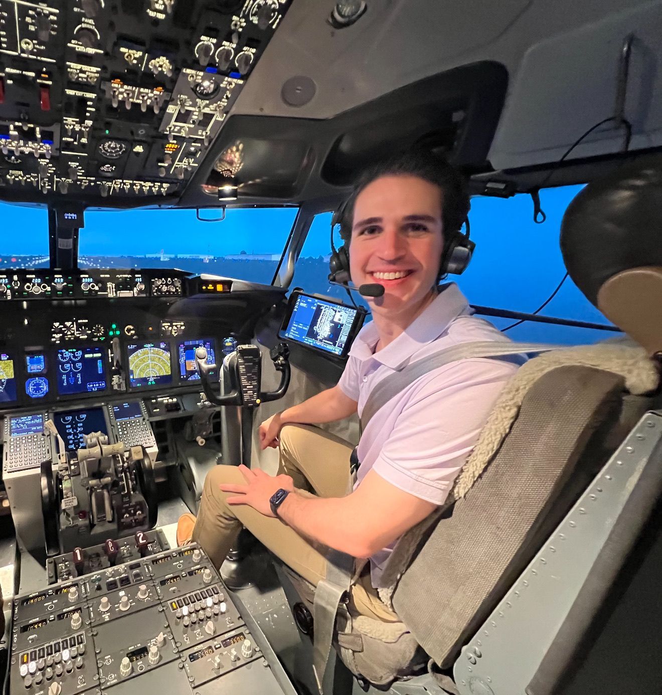 A yellow dice with a smiley face on it is sitting on the ground.