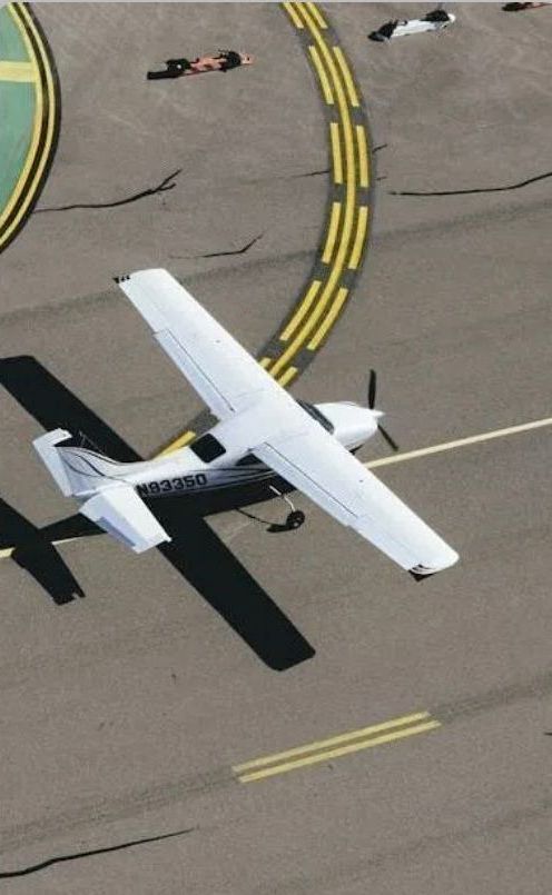 A small propeller plane is taking off from an airport runway