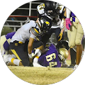 A group of football players are playing a game on a field.