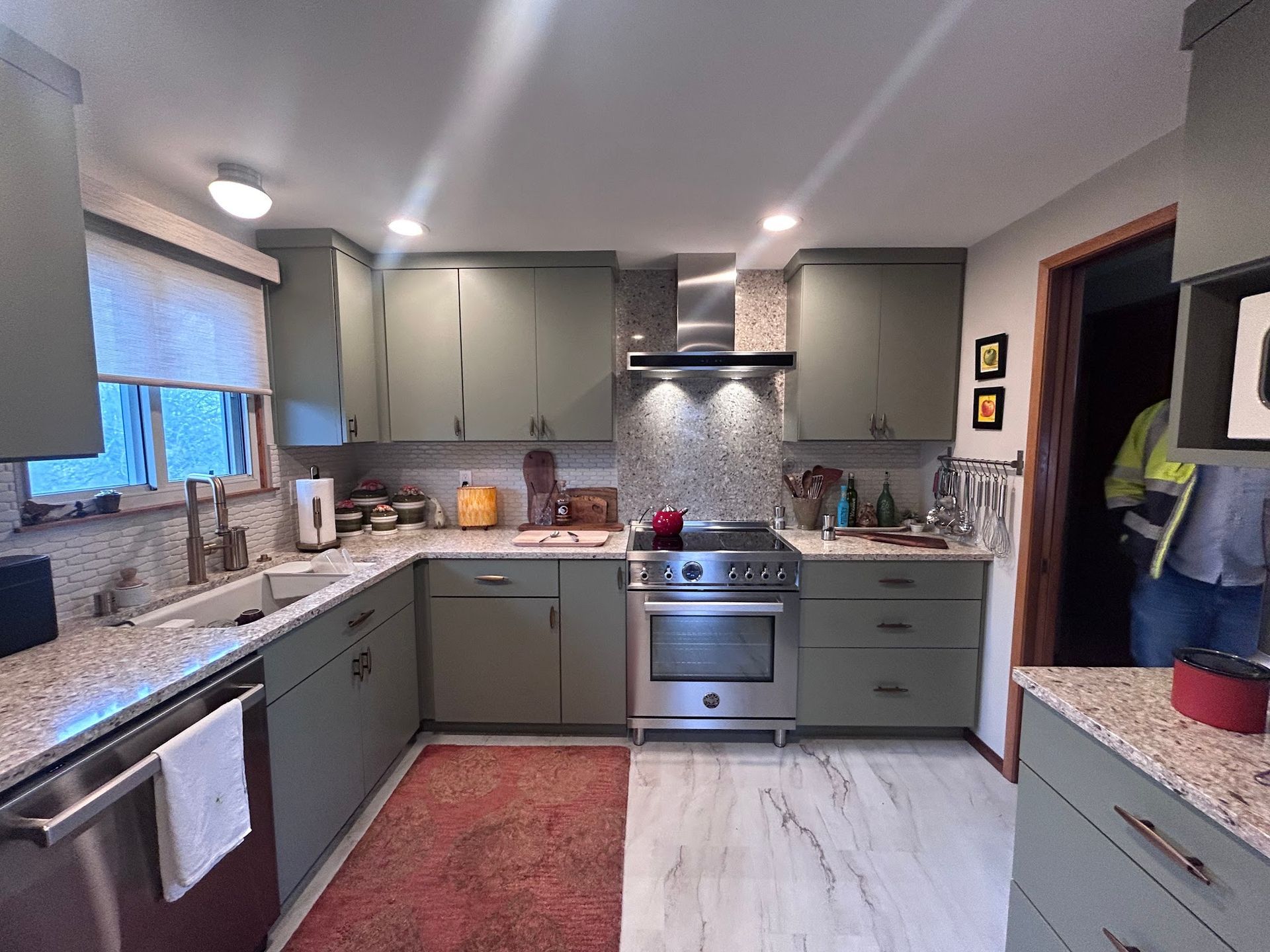 Kitchen with olive-green cabinets, stainless steel appliances, and