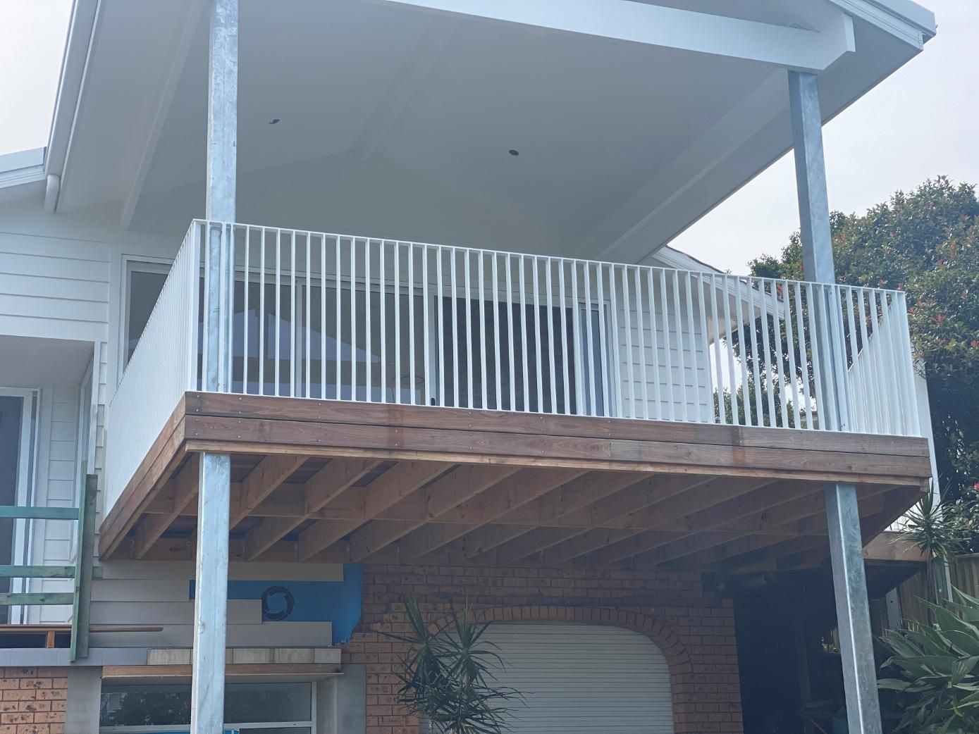 A House With a Balcony and a White Railing — Lifestyle Aluminium Fabrication In Kiama, NSW