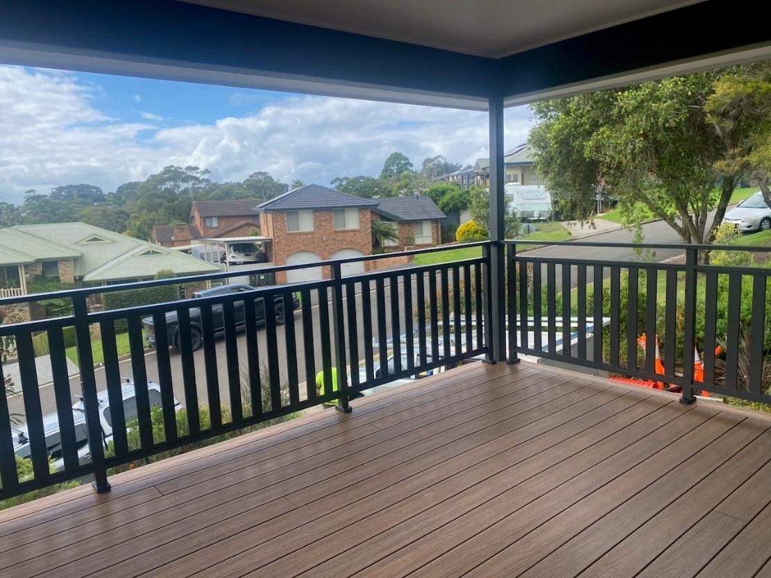 An Empty Deck With a Black Railing and a View of a Residential Area — Lifestyle Aluminium Fabrication In Wollongong, NSW