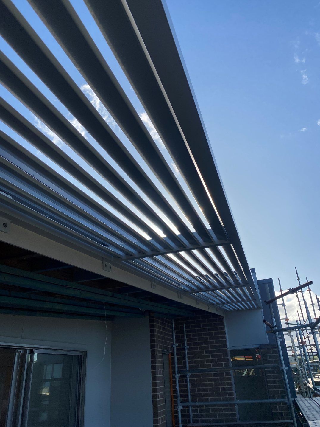 A Building Under Construction with A Blue Sky in The Background — Lifestyle Aluminium Fabrication In Albion Park Rail, NSW