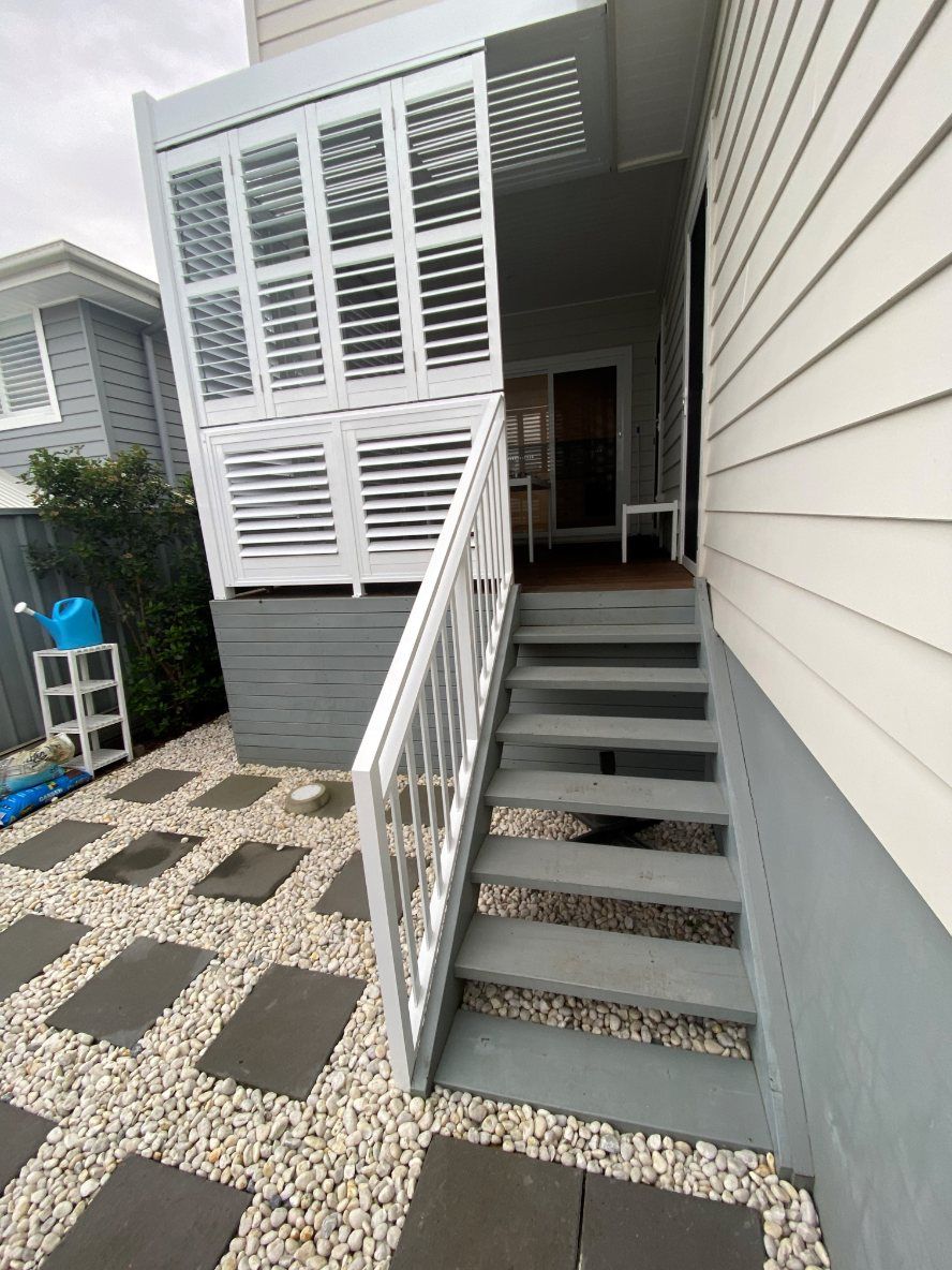 A House with A Fence and Shutters on The Side of It — Lifestyle Aluminium Fabrication In Albion Park Rail, NSW