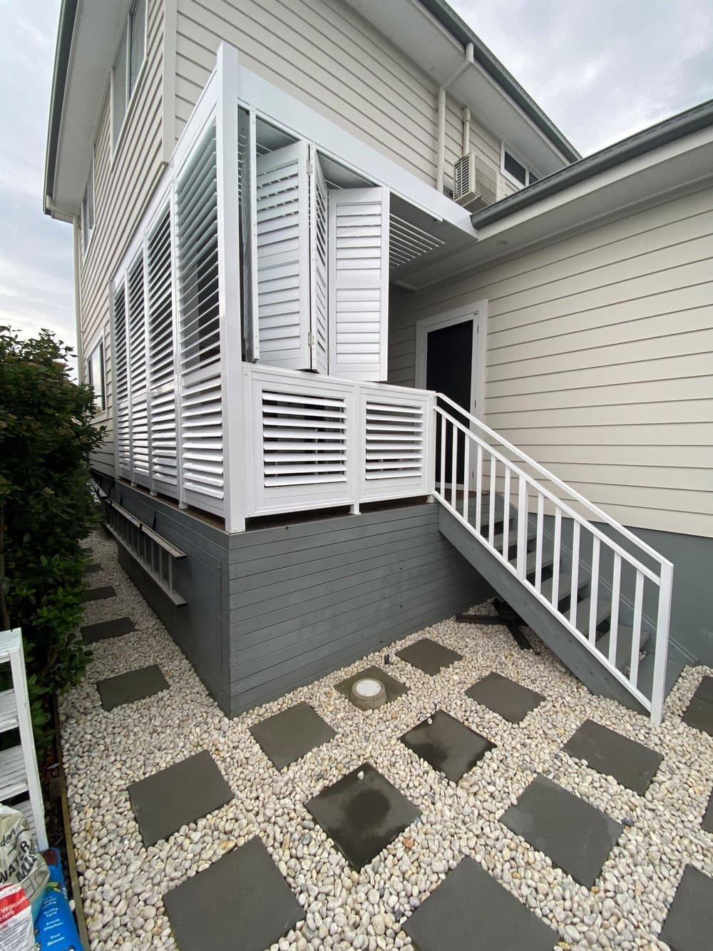 A House With A Porch And Stairs On The Side Of It — Lifestyle Aluminium Fabrication In Kiama, NSW