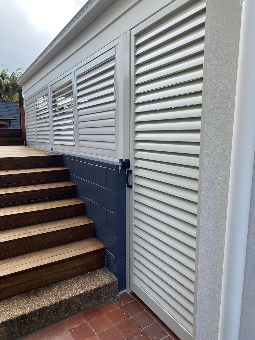 A White Door With Shutters on It is Next to a Set of Stairs — Lifestyle Aluminium Fabrication In Fairy Meadow, NSW