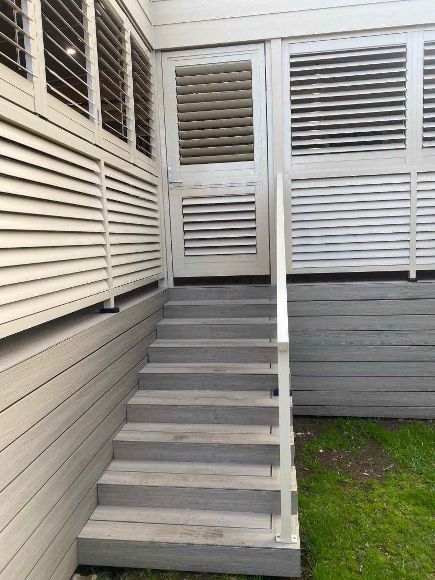 A Set of Stairs Leading up To a Door on The Side of A Building — Lifestyle Aluminium Fabrication In Albion Park Rail, NSW