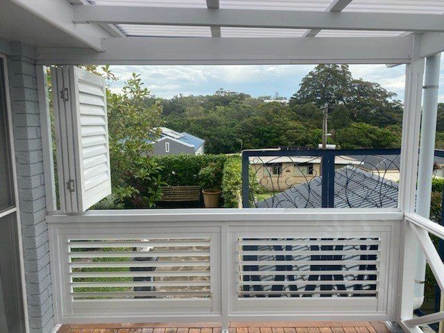 A Balcony with Shutters on It and A View of A House — Lifestyle Aluminium Fabrication In Albion Park Rail, NSW