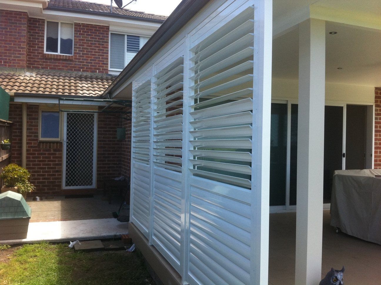 A House with White Shutters on The Side of It — Lifestyle Aluminium Fabrication In Albion Park Rail, NSW