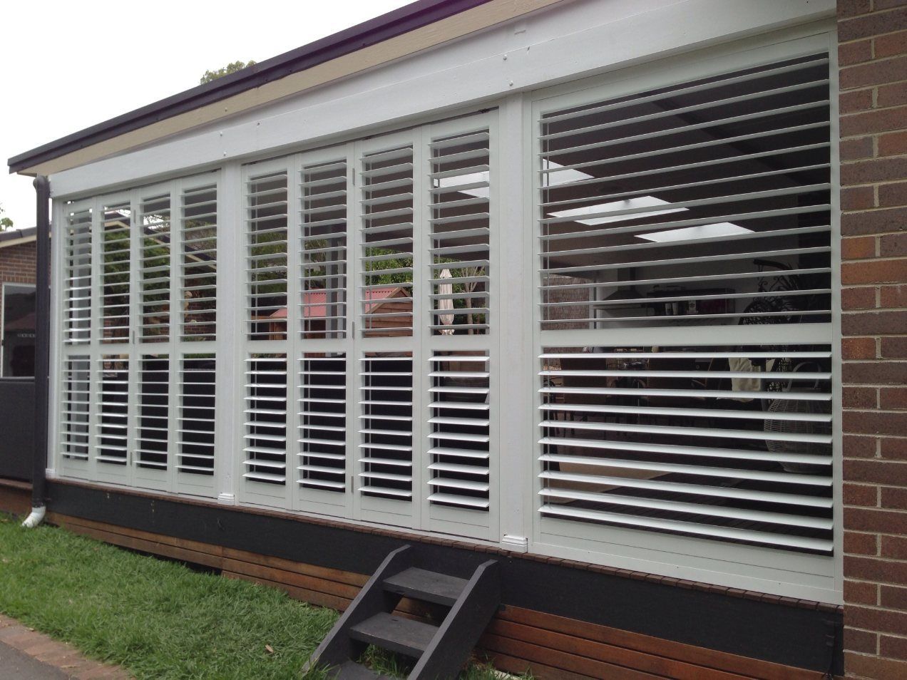 A House with A Lot of Shutters on The Windows — Lifestyle Aluminium Fabrication In Albion Park Rail, NSW