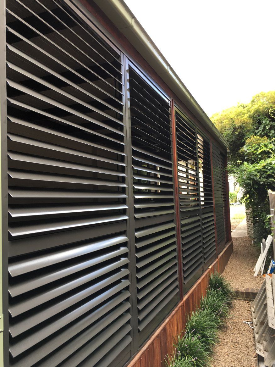 A Building with A Lot of Shutters on The Side of It — Lifestyle Aluminium Fabrication In Albion Park Rail, NSW