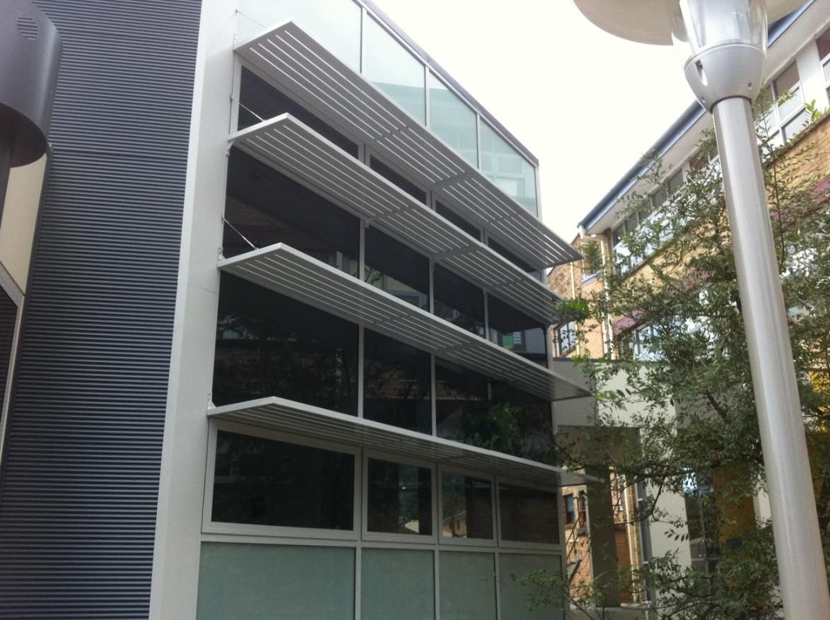 A Building With a Lot of Windows and a Lamp Post in Front of It — Lifestyle Aluminium Fabrication In Fairy Meadow, NSW