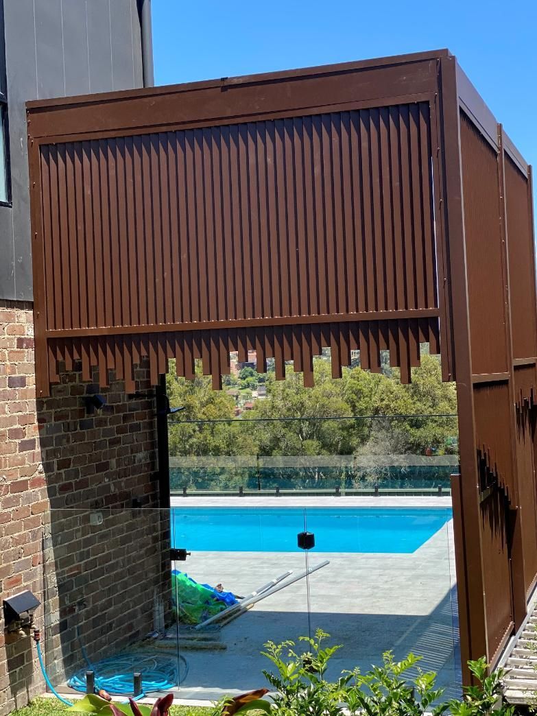 There is a Swimming Pool in the Backyard of a House — Lifestyle Aluminium Fabrication In Kiama, NSW