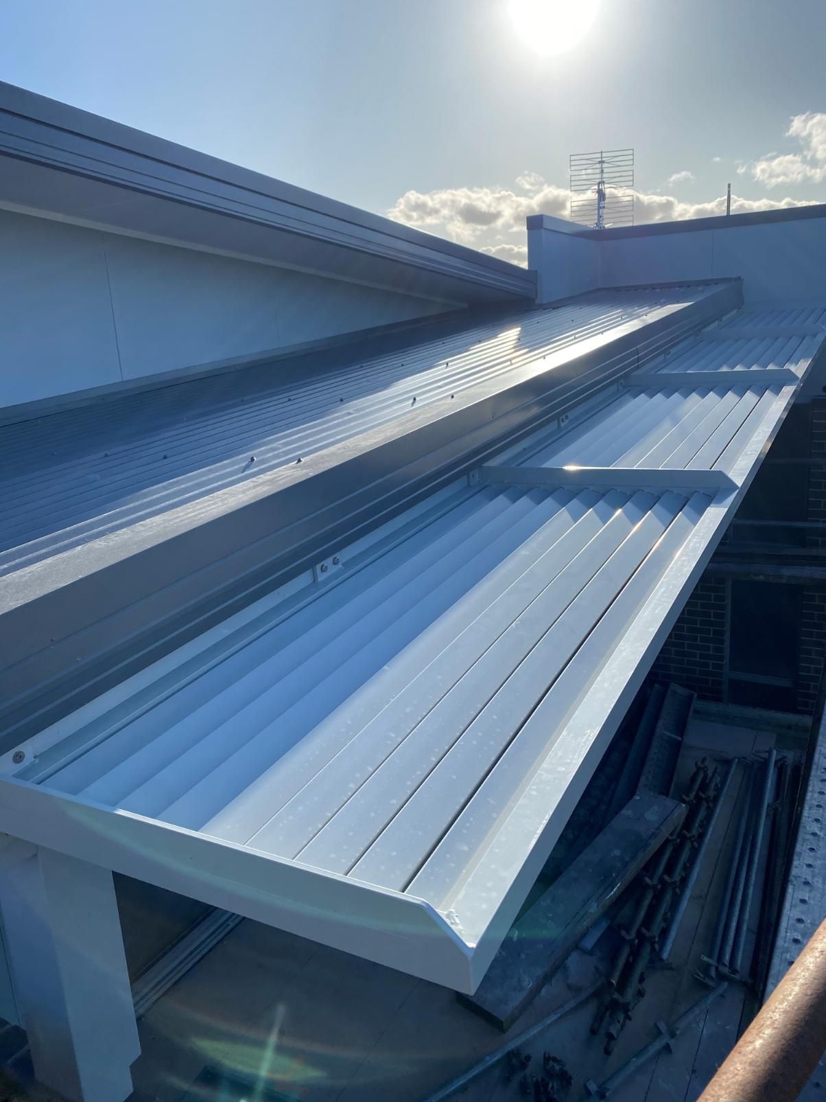 The Roof of a Building With a White Awning on It — Lifestyle Aluminium Fabrication In Shellharbour, NSW