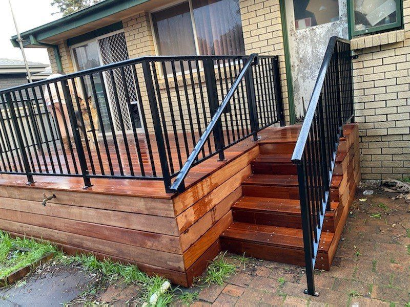 A Wooden Deck with Stairs and A Metal Railing — Lifestyle Aluminium Fabrication In Albion Park Rail, NSW