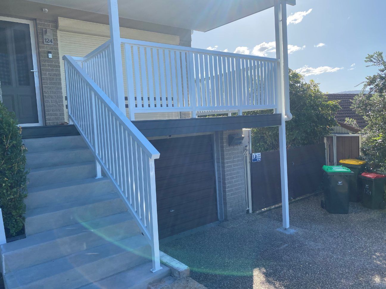 A White Staircase Leading up To a Balcony on Top of A House — Lifestyle Aluminium Fabrication In Albion Park Rail, NSW