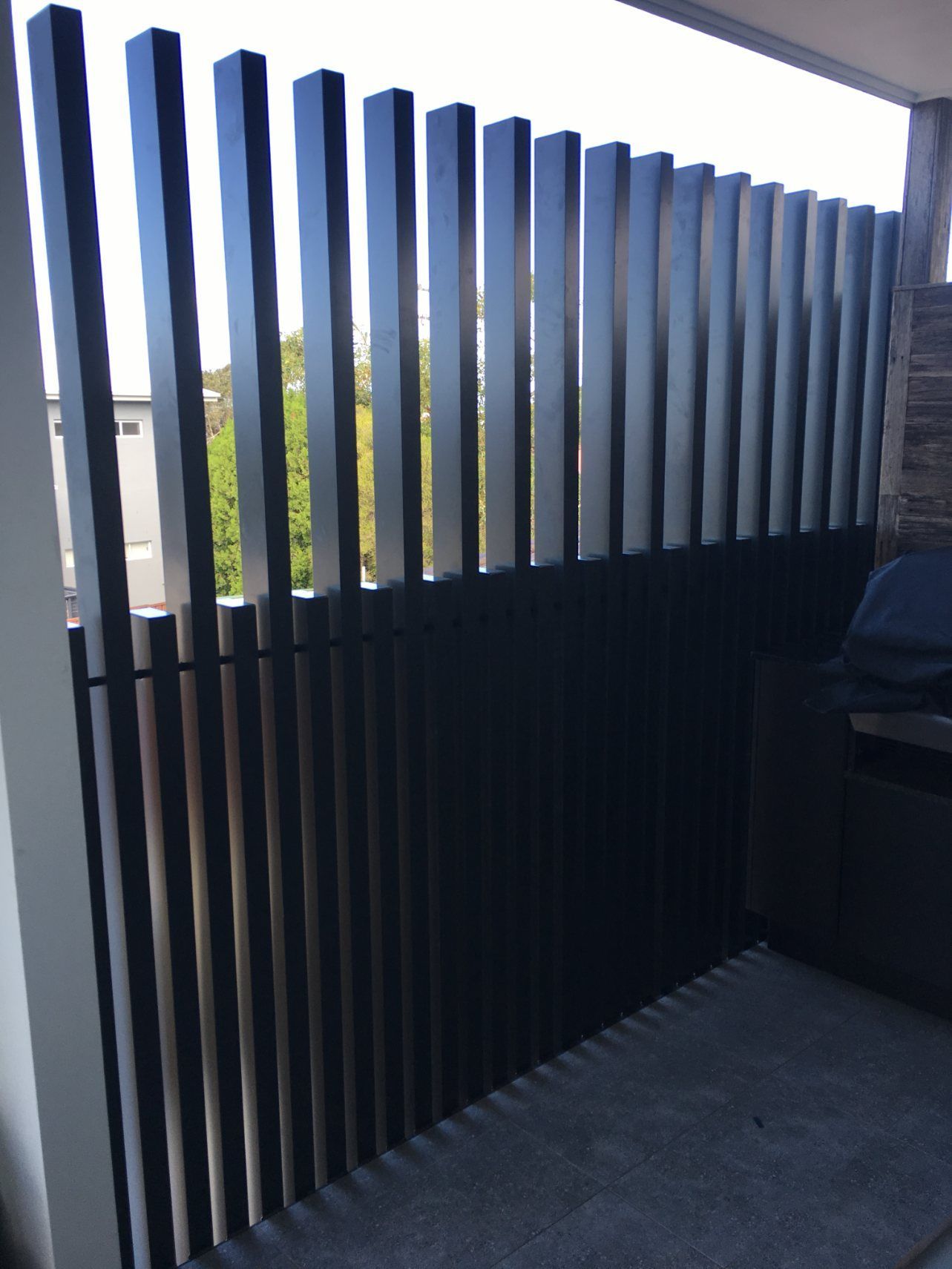 A Balcony with A Black Fence and A Grill — Lifestyle Aluminium Fabrication In Albion Park Rail, NSW