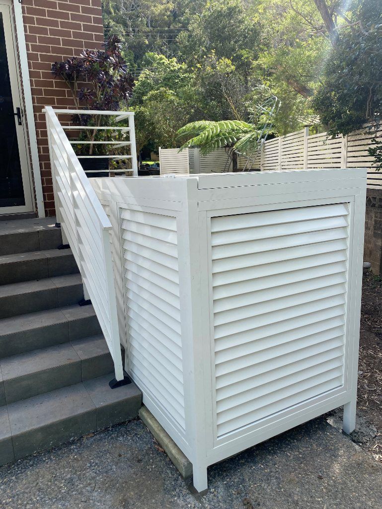 A White Fence Is Sitting Next to A Set of Stairs — Lifestyle Aluminium Fabrication In Albion Park Rail, NSW