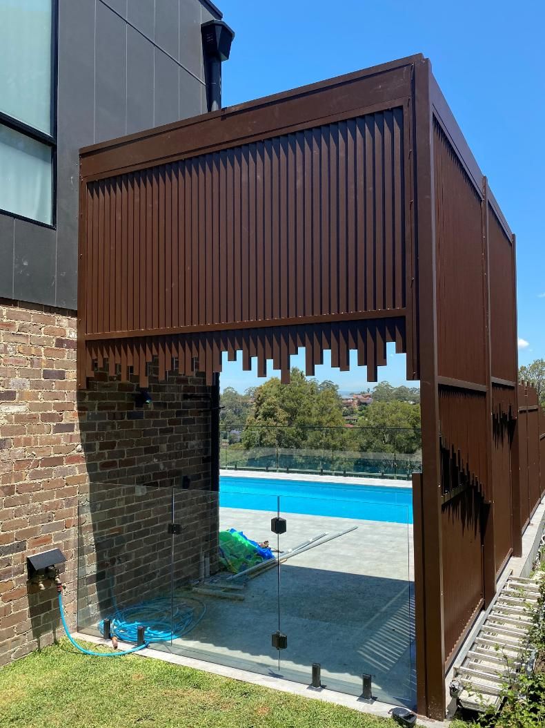 There is a Swimming Pool in the Backyard of a House — Lifestyle Aluminium Fabrication In Kiama, NSW