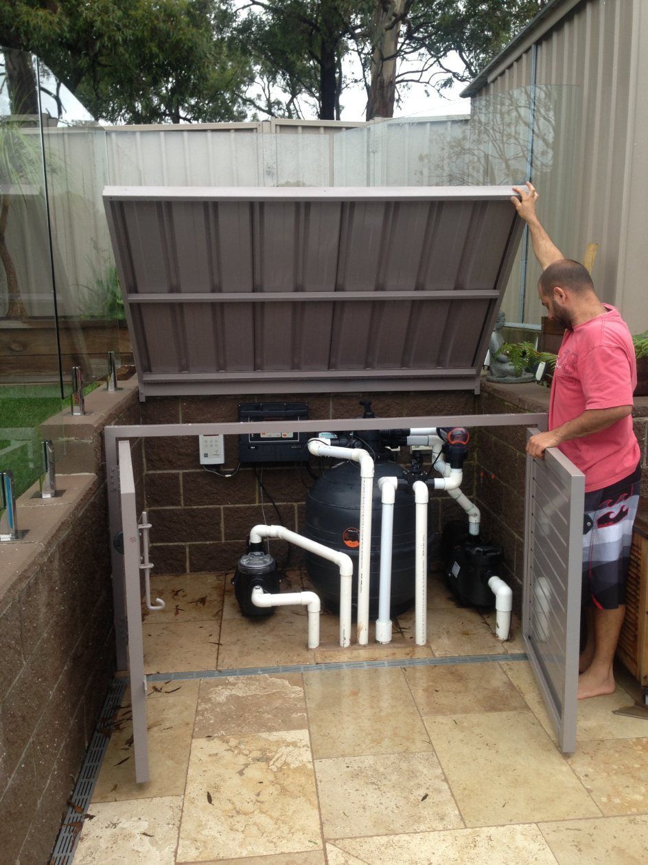A Man in A Pink Shirt Is Working on A Swimming Pool — Lifestyle Aluminium Fabrication In Albion Park Rail, NSW