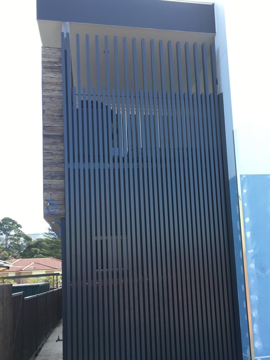 A Building with A Black Fence on The Side of It — Lifestyle Aluminium Fabrication In Albion Park Rail, NSW