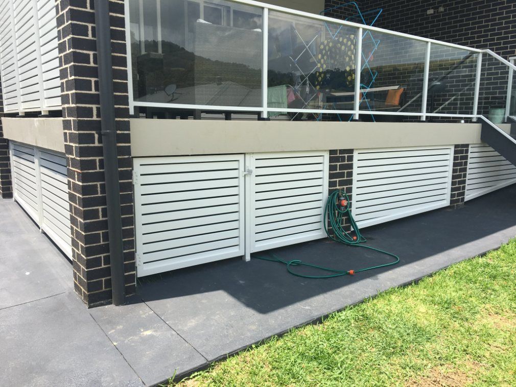 A Hose Is Laying on The Sidewalk in Front of A House — Lifestyle Aluminium Fabrication In Albion Park Rail, NSW